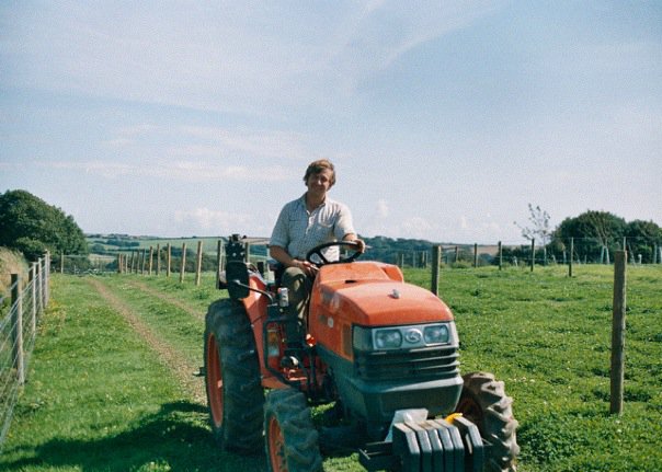 Founder of Nearly Naked Veg farming on his tractor 
